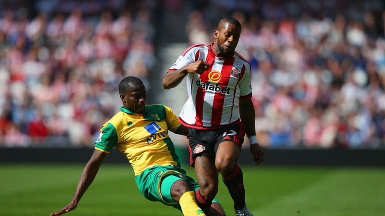 Jeremain Lens of Sunderland and Sebastien Bassong of Norwich City compete for the ball