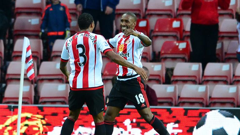 Jermain Defoe (r) celebrates scoring the opening goal with team mate Patrick Van Anholt against Exeter