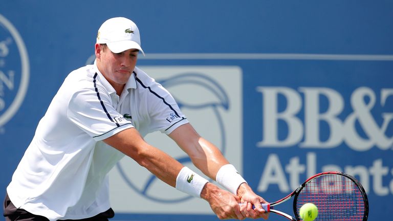 John Isner returns a backhand to Ricardas Berankis of Lithuania during the BB&T Atlanta Open