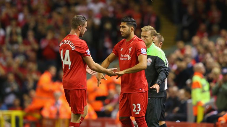 Jordan Henderson of Liverpool shakes hands with team mate Emre Can as he is substituted.