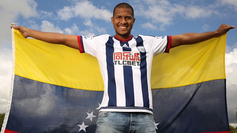 Jose Salomon Rondon poses with the flag of Venezuela as he is unveiled by West Brom