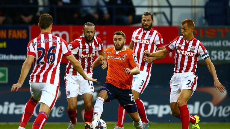 Josh McQuoid of Luton Town takes on the Stoke City defence (L-R) Philipp Wollscheid, Marc Wilson, Erik Pieters and Steve Sidwell