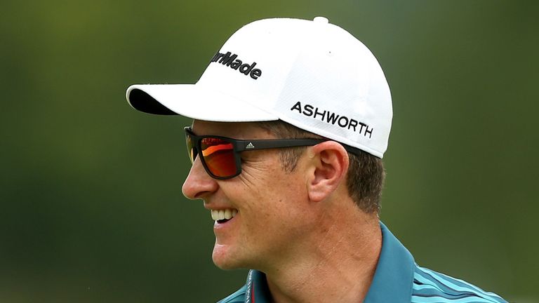 Justin Rose smiles after a birdie putt on the first green during the third round of the World Golf Championships - Bridgestone Invitional