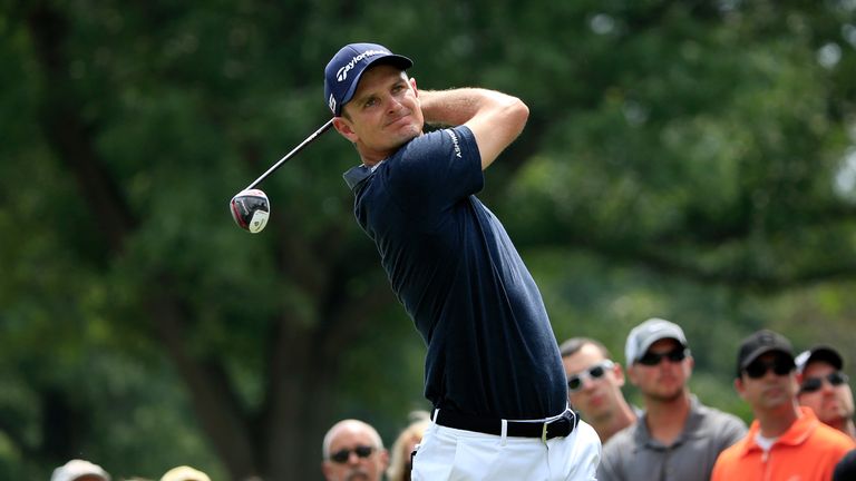 Justin Rose of England hits off the third tee