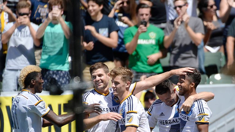 Giovani Dos Santos #10 of the Los Angeles Galaxy is congratulated by teammates from left to right Gyasi Zardes #11, Steven Gerrard #8