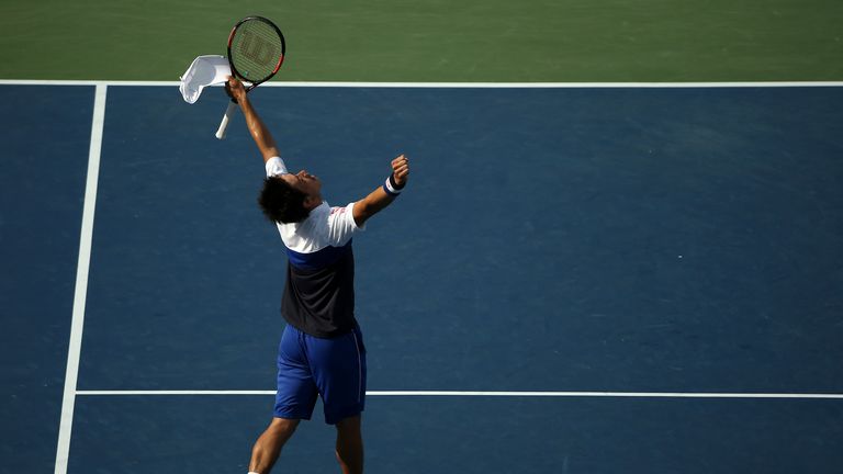 Kei Nishikori celebrates after defeating John Isner in the Washington Open.