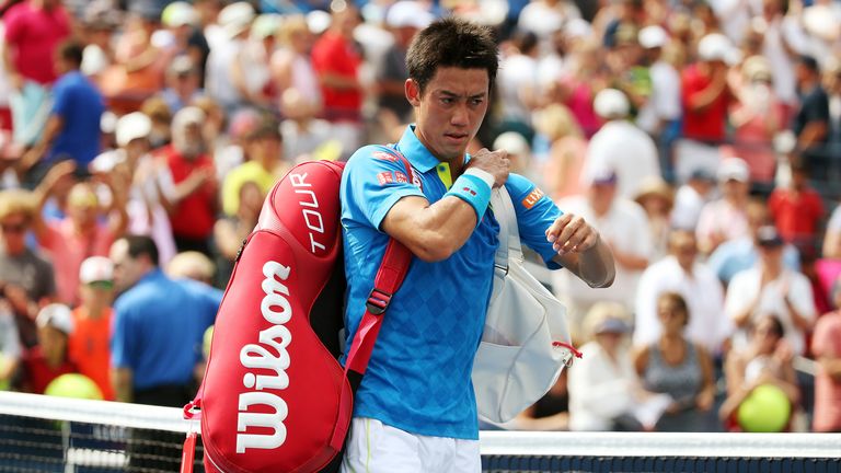 Kei Nishikori walks off of the court after losing against Benoit Paire at the US Open 