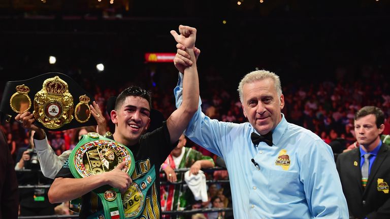 Leo Santa Cruz has his hand held up by the referee as he is annouced as the winner beating Abner Mares