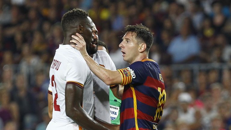 AS Roma's French defender Mapou Yanga-Mbiwa (L) is touched by Barcelona's Argentinian forward Lionel Messi