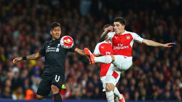 Liverpool's Roberto Firmino of Liverpool is challenged by Hector Bellerin of Arsenal
