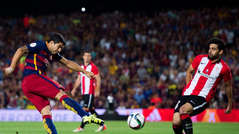 Luis Suarez of FC Barcelona kicks the ball next to Eneko Boveda of Athletic Bilbao