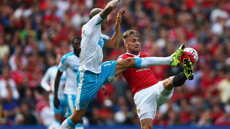 Luke Shaw of Manchester United and Gabriel Obertan of Newcastle compete for the ball 