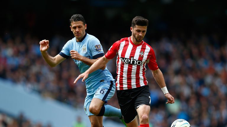 Shane Long of Southampton and Martin Demichelis of Manchester City compete