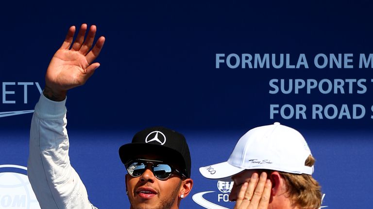 Lewis Hamilton celebrates in Parc Ferme next to Nico Rosberg