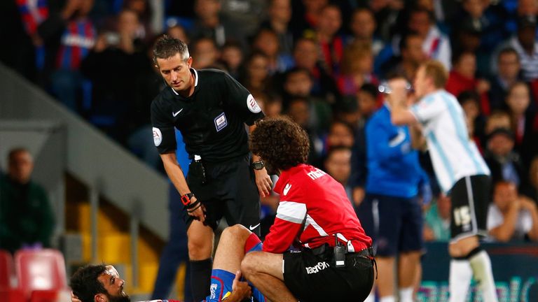 Mile Jedinak of Crystal Palace receives treatment during the Capital One Cup second round match against Shrewsbury