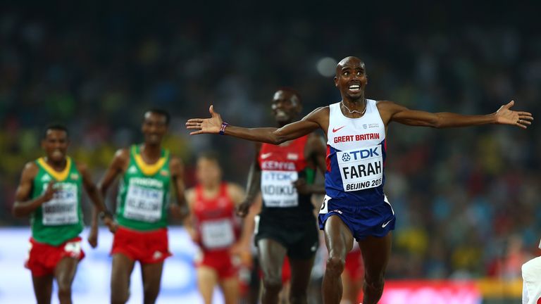 Mohamed Farah of Great Britain crosses the finish line to win gold in the Men's 5000 metres final 