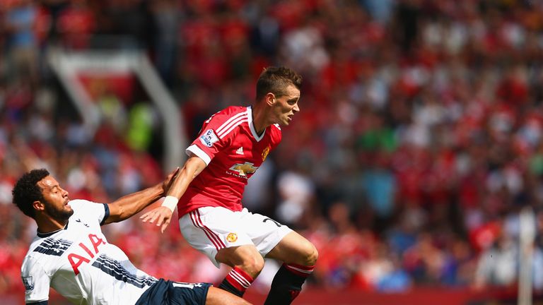 Morgan Schneiderlin of Manchester United and Mousa Dembele of Tottenham compete for the ball 
