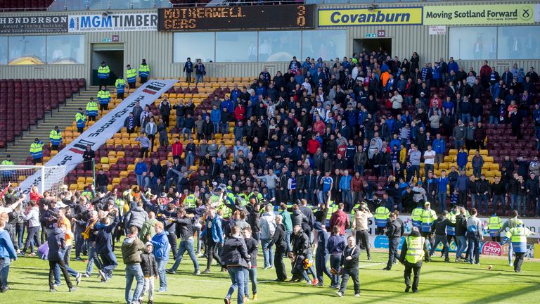 Motherwell fans on the pitch appear to taunt the Rangers fans in the stand at the end of the Scottish Premiership play-off last season. 