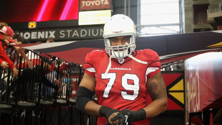 GLENDALE, AZ - DECEMBER 18:  Defensive end David Carter #79 of the Arizona Cardinals walks out onto the field before the NFL game against the Cleveland Bro