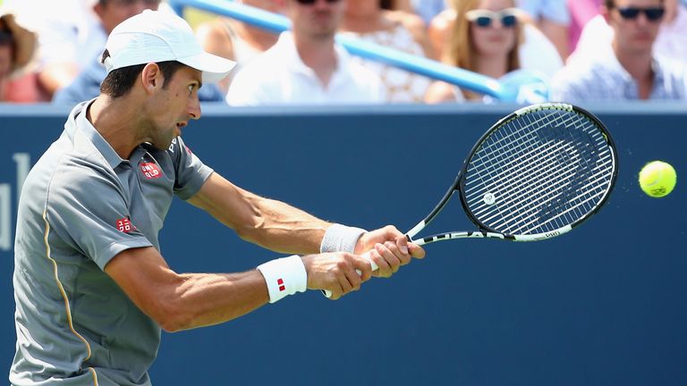Novak Djokovic of Serbia returns a shot to Roger Federer of Switzerland during the final round on Day 9 