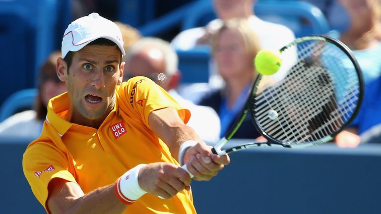 Novak Djokovic of Serbia returns a backhand to Alexandr Dolgopolov of Ukraine during their semifinal match 