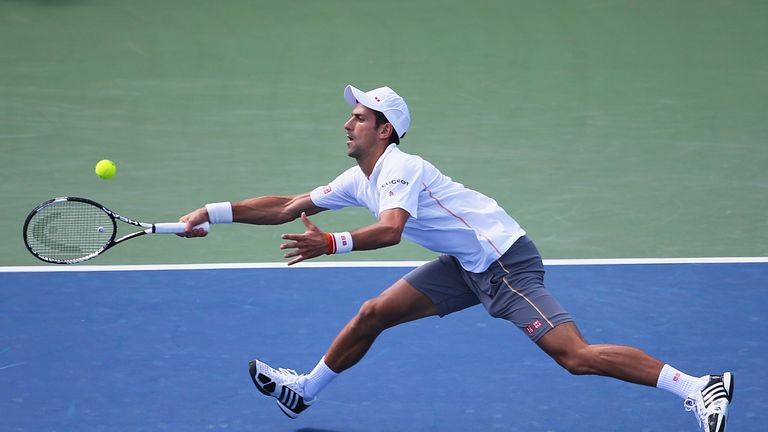 Novak Djokovic of Serbia returns a forehand to Stanislas Wawrinka of Switzerland