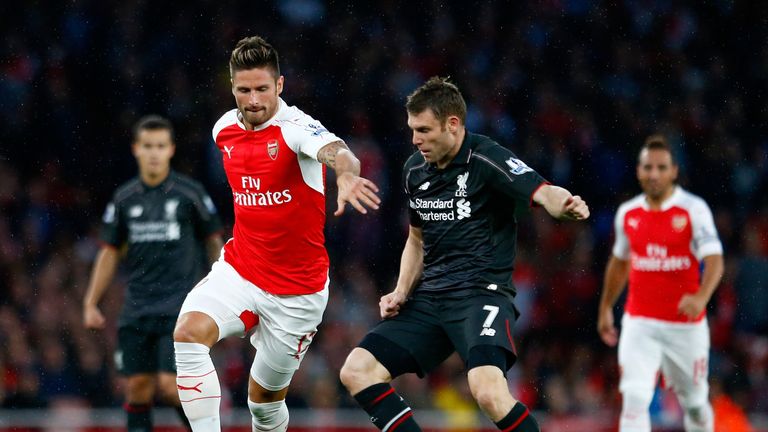 Olivier Giroud and Jame Milner battle for the ball as Arsenal host Liverpool in the Premier League