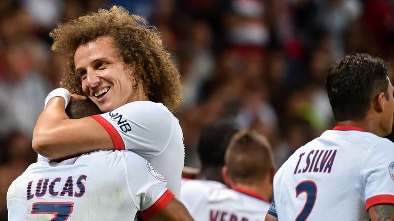 Paris Saint-Germain's Lucas Moura (L) celebrates with David Luiz