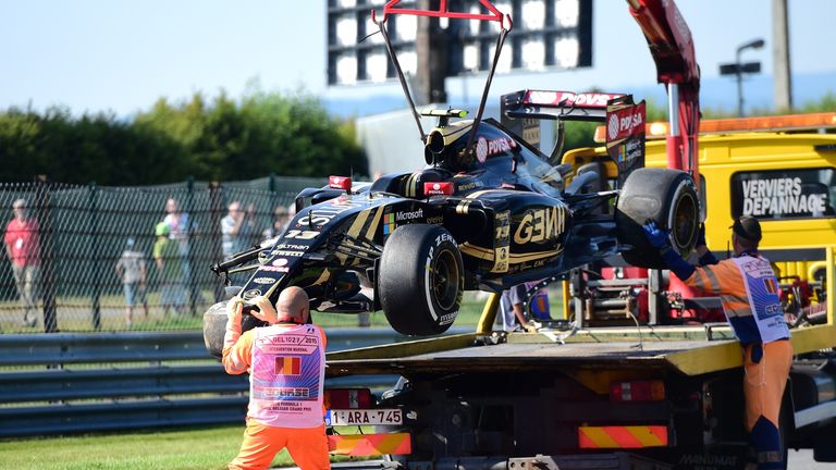Pastor Maldonado's crashed Lotus is cleared away