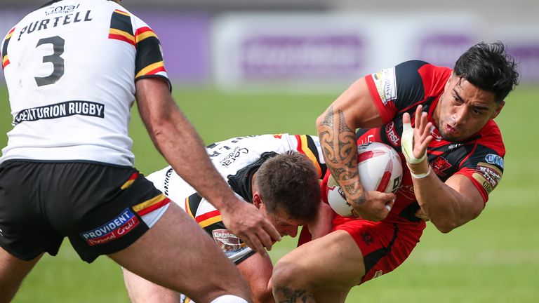 Salford's Rangi Chase is tackled by Bradford's Jake Mullaney