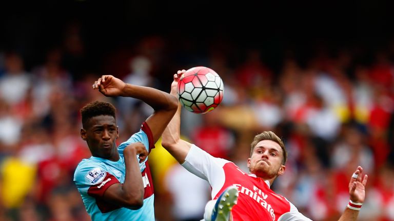 LONDON, ENGLAND - AUGUST 09:  Reece Oxford of West Ham United and Aaron Ramsey of Arsenal battle for the ball during the Barclays Premier League match betw