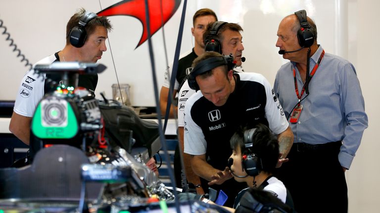 Ron Dennis in the McLaren garage as the engine is worked on