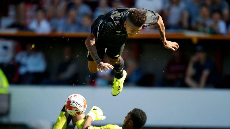 Liverpool's Roberto Firmino (top) and Swindon Town's Lawrence Vigouroux