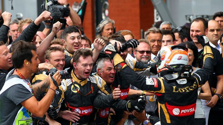 Romain Grosjean celebrates with his Lotus mechanics after finishing third at Spa