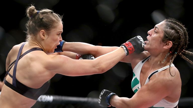 Ronda Rousey (left) fights Bethe Correia in their bantamweight title fight during the UFC 190