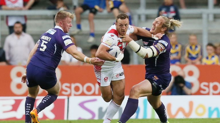 St Helens' James Roby is tackled by Huddersfield Giants duo Eorl Crabtree and Aaron Murphy