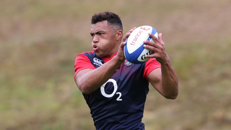 Luther Burrell runs with the ball during an England training session