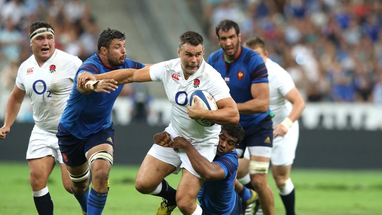 Nick Easter of England is tackled by Damien Chouly and Noa Nakaitaci