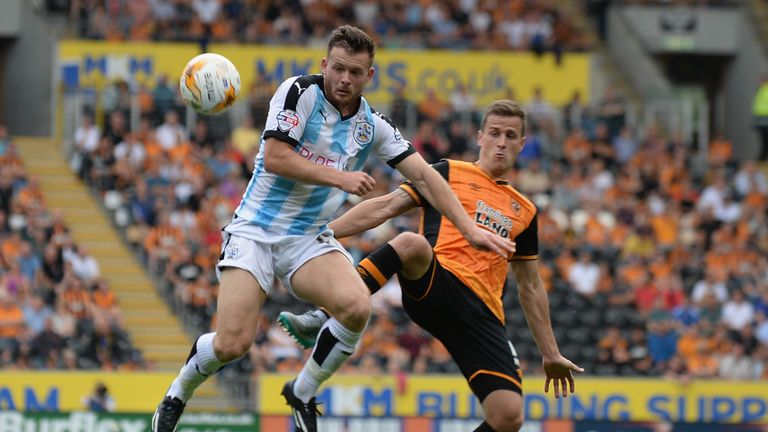 Ryan Taylor of Hull City is tackled by Harry Bunn of Huddersfield Town