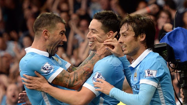 Samir Nasri celebrates with Aleksandar Kolarov and David Silva