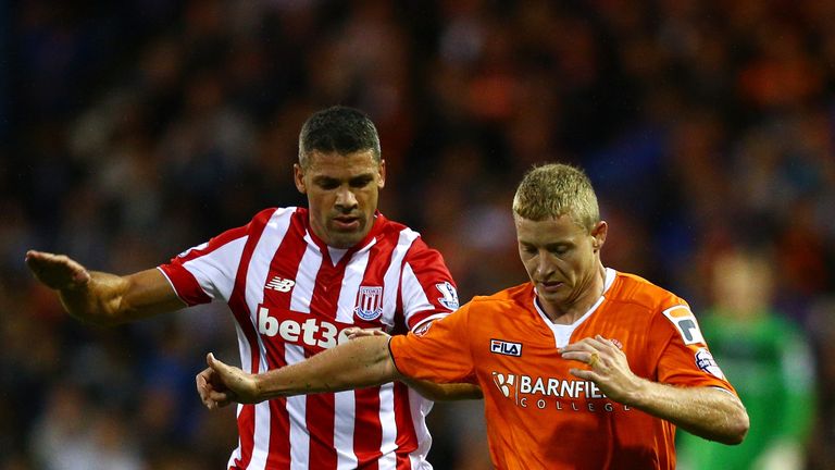 Scott Griffiths of Luton Town is closed down by Jonathan Walters of Stoke City during the Capital One Cup second round match