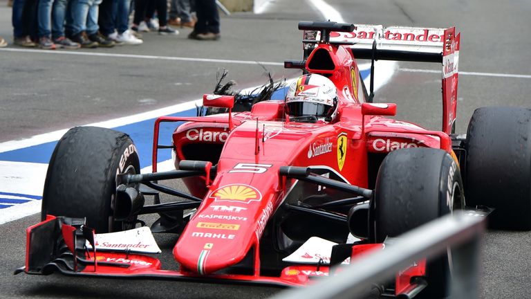 Sebastian Vettel drags his Ferrari back to the pits after its right-rear tyre let go