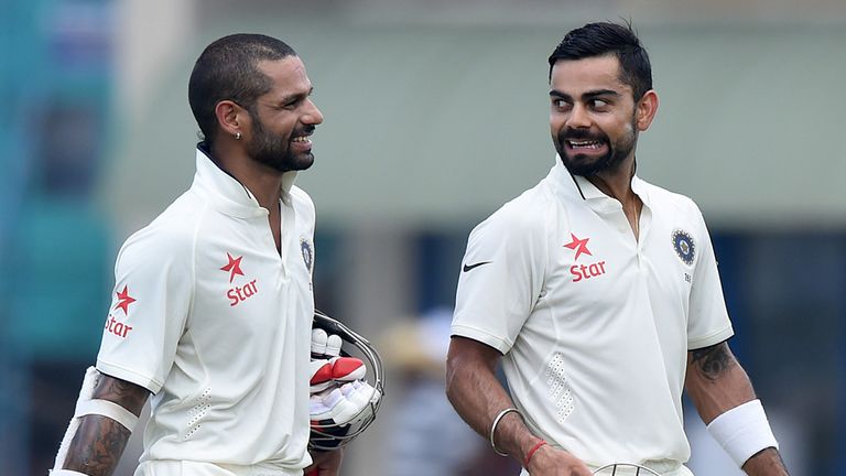 India's Virat Kohli (R) and Shikhar Dhawan leave the field for lunch during the second day of the opening Test match v Sri Lanka