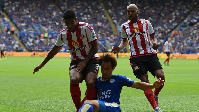 Shinji Okazaki of Leicester City tackles Patrick van Aanholt of Sunderland during the Barclays Premier League match between