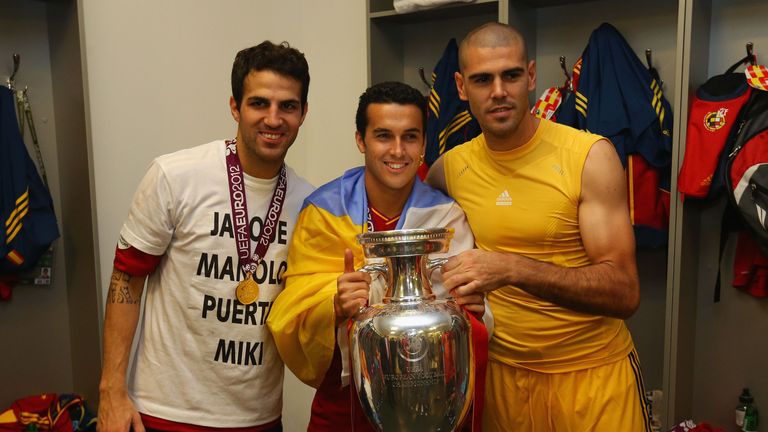 Cesc Fabregas,  Pedro and Victor Valdes of Spain pose with the trophy in the dressing room following the UEFA EURO 2012 final win over Italy