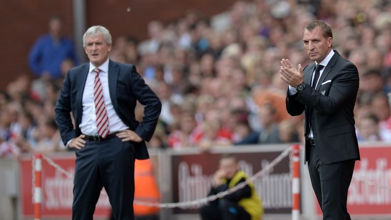 Stoke City manager Mark Hughes (left) and Liverpool boss Brendan Rodgers watch from the sidelines