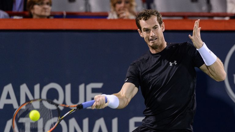 Andy Murray of Great Britain hits a return against Jo-Wilfried Tsonga of France during day five of the Montreal Masters