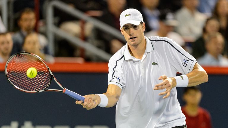John Isner hits a return against Vasek Pospisil during day three of the Montreal Masters