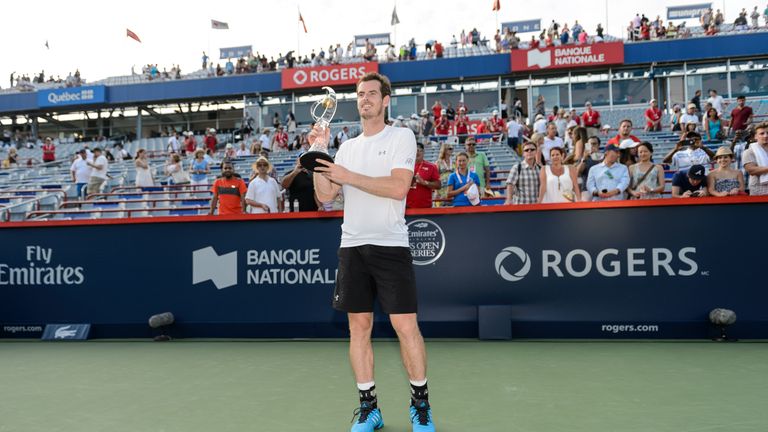 Andy Murray holds up the trophy after defeating Novak Djokovic at the Montreal Masters