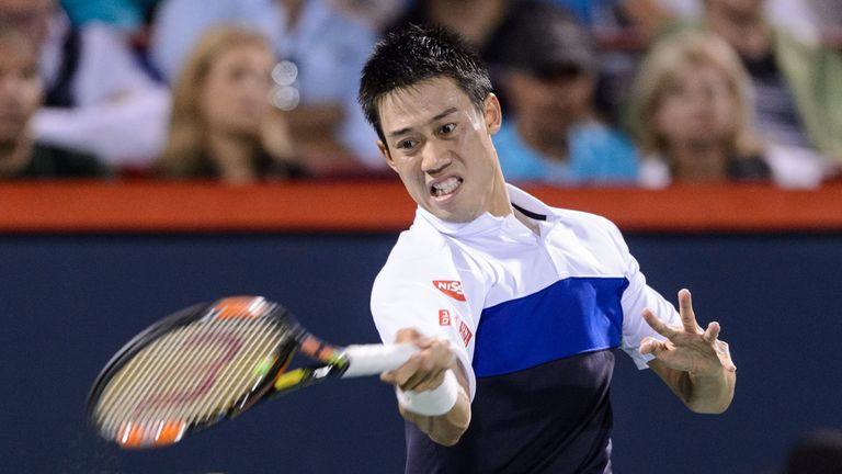Kei Nishikori of Japan hits a return against Rafael Nadal of Spain during day five of the Montreal Masters